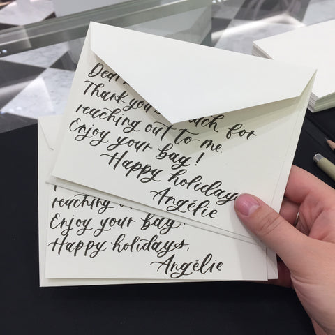 Two white note cards with modern calligraphy