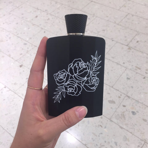 Black Atkinsons 41 Burlington Arcade perfume bottle on display with custom white floral illustration by Chalked by Mabz in Montreal