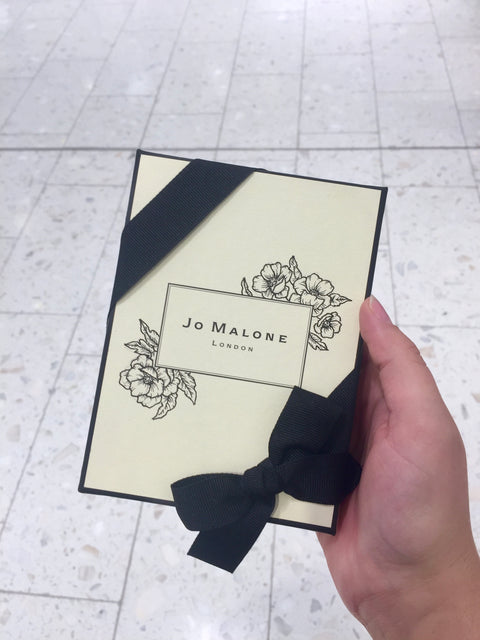 Jo Malone London gift box is decorated with hand drawn florals by Chalked by Mabz. The box is a beautiful cream colour and it is tied wth a black ribbon which matches the illustrations and logo for a luxurious look.